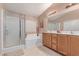 Main bathroom featuring a glass-enclosed shower, soaking tub, and dual sink vanity at 6954 Jacksboro Ct, North Las Vegas, NV 89084