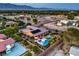 Scenic aerial view of a backyard featuring a sparkling pool, lounge area, and solar panels, nestled in a residential neighborhood at 7111 Bath Dr, Las Vegas, NV 89131