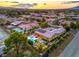 Panoramic aerial shot of a home with a swimming pool, stylish patio furniture, and solar panels surrounded by mature trees at 7111 Bath Dr, Las Vegas, NV 89131