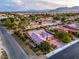 Expansive aerial view of a suburban home showcasing its well-maintained landscape, illuminated interiors, and peaceful surroundings at 7111 Bath Dr, Las Vegas, NV 89131