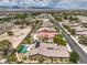 Aerial view of a neighborhood featuring mature landscaping, swimming pools and well-maintained homes with mountain views at 7111 Bath Dr, Las Vegas, NV 89131