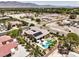 Aerial view of a home with a backyard pool, spa, and meticulous landscaping in a neighborhood setting at 7111 Bath Dr, Las Vegas, NV 89131
