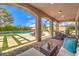 Inviting covered patio with outdoor furniture overlooking the swimming pool and manicured landscaping at 7111 Bath Dr, Las Vegas, NV 89131