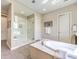 Bright bathroom featuring a soaking tub and a frameless glass shower, offering a spa-like experience at 7111 Bath Dr, Las Vegas, NV 89131