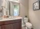 Powder room with a modern vanity, decorative mirror, and stylish fixtures creates a chic, functional space at 7111 Bath Dr, Las Vegas, NV 89131