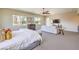 Spacious bedroom featuring a ceiling fan, a seating area, and plenty of natural light at 7111 Bath Dr, Las Vegas, NV 89131