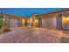 Spacious three-car garage and brick driveway enhance the home's exterior appeal at 7111 Bath Dr, Las Vegas, NV 89131