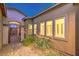 Charming entryway with decorative shrubs, brick walkway, and stylish front gate at 7111 Bath Dr, Las Vegas, NV 89131
