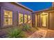 Inviting front entrance featuring decorative door, manicured shrubs and well-lit pathway at 7111 Bath Dr, Las Vegas, NV 89131