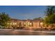 Stunning home with a three-car garage and inviting curb appeal at twilight at 7111 Bath Dr, Las Vegas, NV 89131