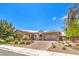 Charming single-story home with a well-manicured front yard and a brick driveway at 7111 Bath Dr, Las Vegas, NV 89131