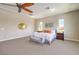Spacious main bedroom featuring a comfortable seating area, plush carpeting, and an elegant ceiling fan at 7111 Bath Dr, Las Vegas, NV 89131