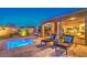 Private backyard pool area with chaise lounges and a covered patio, offering a luxurious outdoor experience at 7111 Bath Dr, Las Vegas, NV 89131