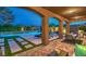 Picturesque backyard with a pool, covered patio with furniture, and lush landscaping for outdoor living at 7111 Bath Dr, Las Vegas, NV 89131