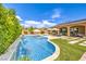 Sparkling pool and lush backyard landscaping create a serene outdoor living space at 7111 Bath Dr, Las Vegas, NV 89131