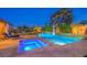 Inviting backyard pool and spa featuring stepping stones, lounge chairs, and lush landscaping, perfect for relaxation at 7111 Bath Dr, Las Vegas, NV 89131