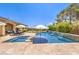 Relaxing pool and spa area with lounge chairs and umbrellas, perfect for outdoor enjoyment at 7111 Bath Dr, Las Vegas, NV 89131