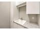 Functional utility sink area with gray counter, cabinet storage, and minimalist design at 7111 Bath Dr, Las Vegas, NV 89131