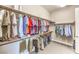 Organized walk-in closet with ample hanging space, shelving and room for accessories at 7111 Bath Dr, Las Vegas, NV 89131