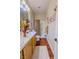 Bathroom with double sinks, wood-look flooring, and a shower-tub combo at 7225 Millerbird St, North Las Vegas, NV 89084