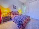 Carpeted bedroom features dark wood furniture, a large window and ample natural light at 7225 Millerbird St, North Las Vegas, NV 89084