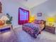 Comfortable bedroom with carpet, dark wood furniture and bright window at 7225 Millerbird St, North Las Vegas, NV 89084