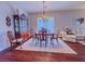 Dining area with classic wooden table set, china cabinet and bright chandelier at 7225 Millerbird St, North Las Vegas, NV 89084