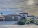 Inviting single-story home with well-maintained landscaping, three-car garage, and modern architectural details at 7225 Millerbird St, North Las Vegas, NV 89084