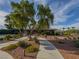 Community building with desert landscaping, sidewalk, and tall tree at 7225 Millerbird St, North Las Vegas, NV 89084