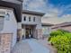 Home's exterior with stone accents, desert landscaping, and inviting covered entryway at 7225 Millerbird St, North Las Vegas, NV 89084