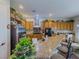 Bright kitchen boasts wooden cabinets, granite counters, stainless appliances, and a breakfast bar area at 7225 Millerbird St, North Las Vegas, NV 89084