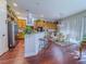 Bright kitchen boasts wooden cabinets, granite counters, stainless appliances, and a breakfast bar area at 7225 Millerbird St, North Las Vegas, NV 89084