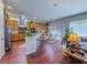 Bright kitchen boasts wooden cabinets, granite counters, stainless appliances, and a breakfast bar area at 7225 Millerbird St, North Las Vegas, NV 89084