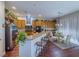 Bright kitchen boasts wooden cabinets, granite counters, stainless appliances, and a breakfast bar area at 7225 Millerbird St, North Las Vegas, NV 89084
