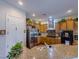 Bright kitchen featuring stainless steel refrigerator, granite countertops, and wood cabinets at 7225 Millerbird St, North Las Vegas, NV 89084