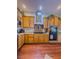 Bright kitchen boasts wooden cabinets, granite counters, stainless appliances, and double oven at 7225 Millerbird St, North Las Vegas, NV 89084