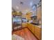 Bright kitchen with wood cabinets, stainless steel appliances, granite counters, and wood flooring at 7225 Millerbird St, North Las Vegas, NV 89084