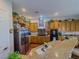 Open kitchen featuring stainless steel refrigerator, granite countertops and tan cabinets at 7225 Millerbird St, North Las Vegas, NV 89084