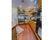 Bright kitchen featuring stainless steel refrigerator, granite countertops, and traditional cabinets at 7225 Millerbird St, North Las Vegas, NV 89084