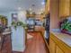 Modern kitchen with stainless steel refrigerator, granite countertops, and traditional wood cabinets at 7225 Millerbird St, North Las Vegas, NV 89084