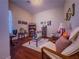 Cozy living room with comfortable seating, a glass-top coffee table, and decorative wall hangings at 7225 Millerbird St, North Las Vegas, NV 89084