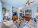 Inviting living room with a fireplace, ceiling fan, and a large window for natural light at 7225 Millerbird St, North Las Vegas, NV 89084
