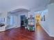 Inviting living room with dark wood floors, white walls, and an archway leading to other rooms at 7225 Millerbird St, North Las Vegas, NV 89084