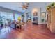 Bright living room with hardwood floors, decorative accents, fireplace, and an open, airy layout at 7225 Millerbird St, North Las Vegas, NV 89084