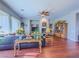 Bright living room with a ceiling fan, wood floors, fireplace, and elegant furnishings at 7225 Millerbird St, North Las Vegas, NV 89084