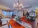 Cozy living room with hardwood floors, an elegant chandelier, and comfortable seating arrangements at 7225 Millerbird St, North Las Vegas, NV 89084