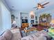 Comfortable living room featuring a cozy fireplace, ceiling fan, and neutral color palette at 7225 Millerbird St, North Las Vegas, NV 89084