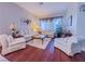 Cozy living room with hardwood floors, plush seating, and a bright, inviting atmosphere at 7225 Millerbird St, North Las Vegas, NV 89084