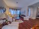 Inviting living room showcasing ample seating, wood floors, and natural light at 7225 Millerbird St, North Las Vegas, NV 89084