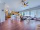 Well-lit living space offering wood floors, an open floor plan, and access to the kitchen at 7225 Millerbird St, North Las Vegas, NV 89084